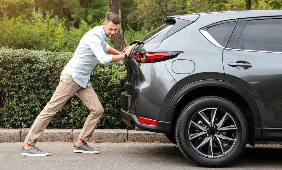 man pushing a lemon car